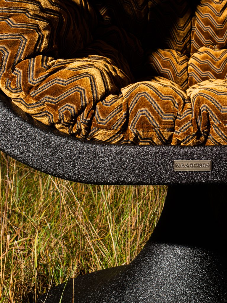 Handcrafted basalt design chair Bucifal by MAARCORA – sculptural form.